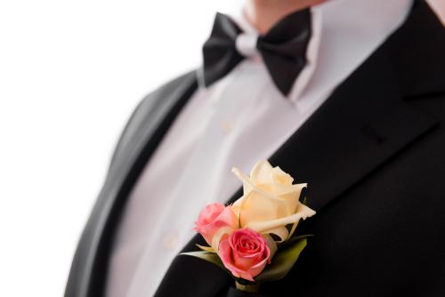 Boutonniere and bowtie close up.